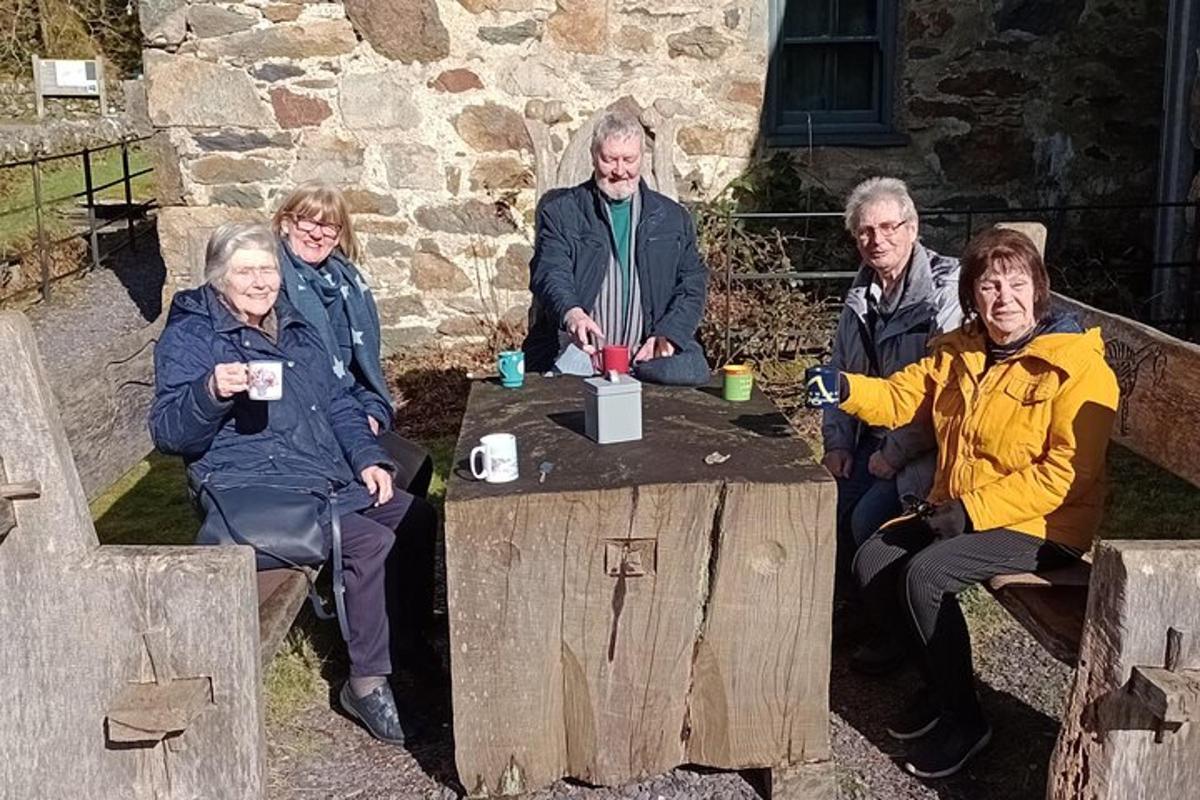a group of people sitting around a wooden table