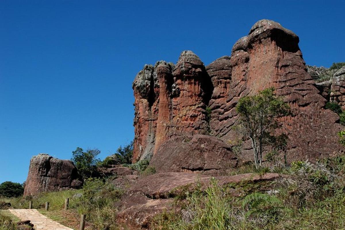 a rocky mountain with a blue sky in the background
