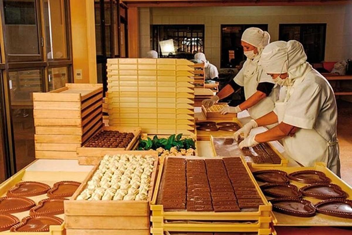 two chefs preparing food in a bakery with chocolate