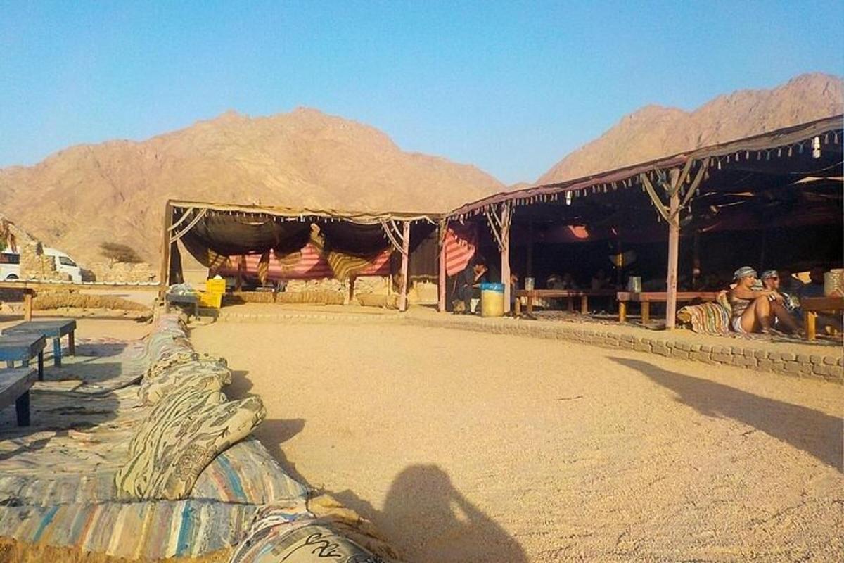 Un edificio en el desierto con montañas al fondo.