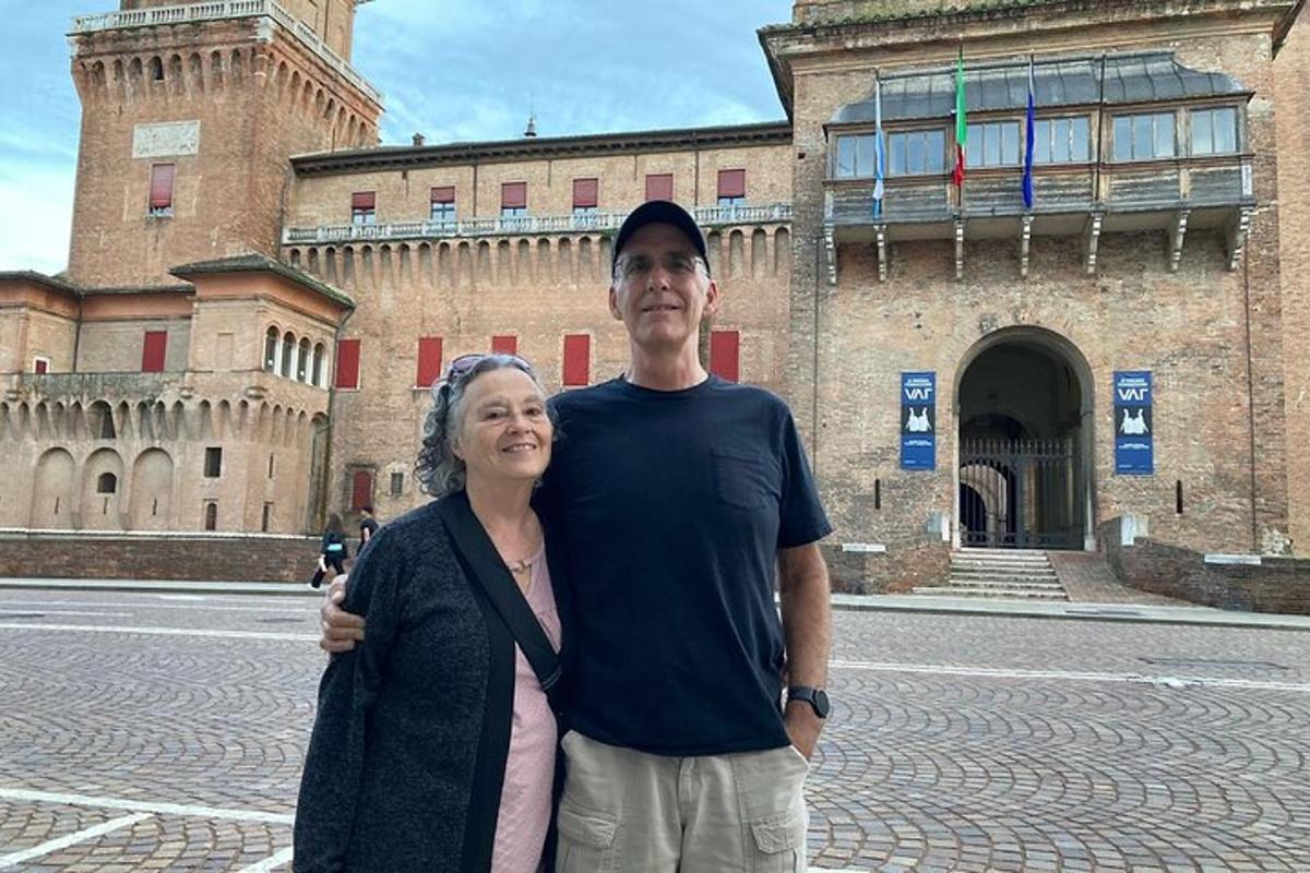 a man and a woman standing in front of a building