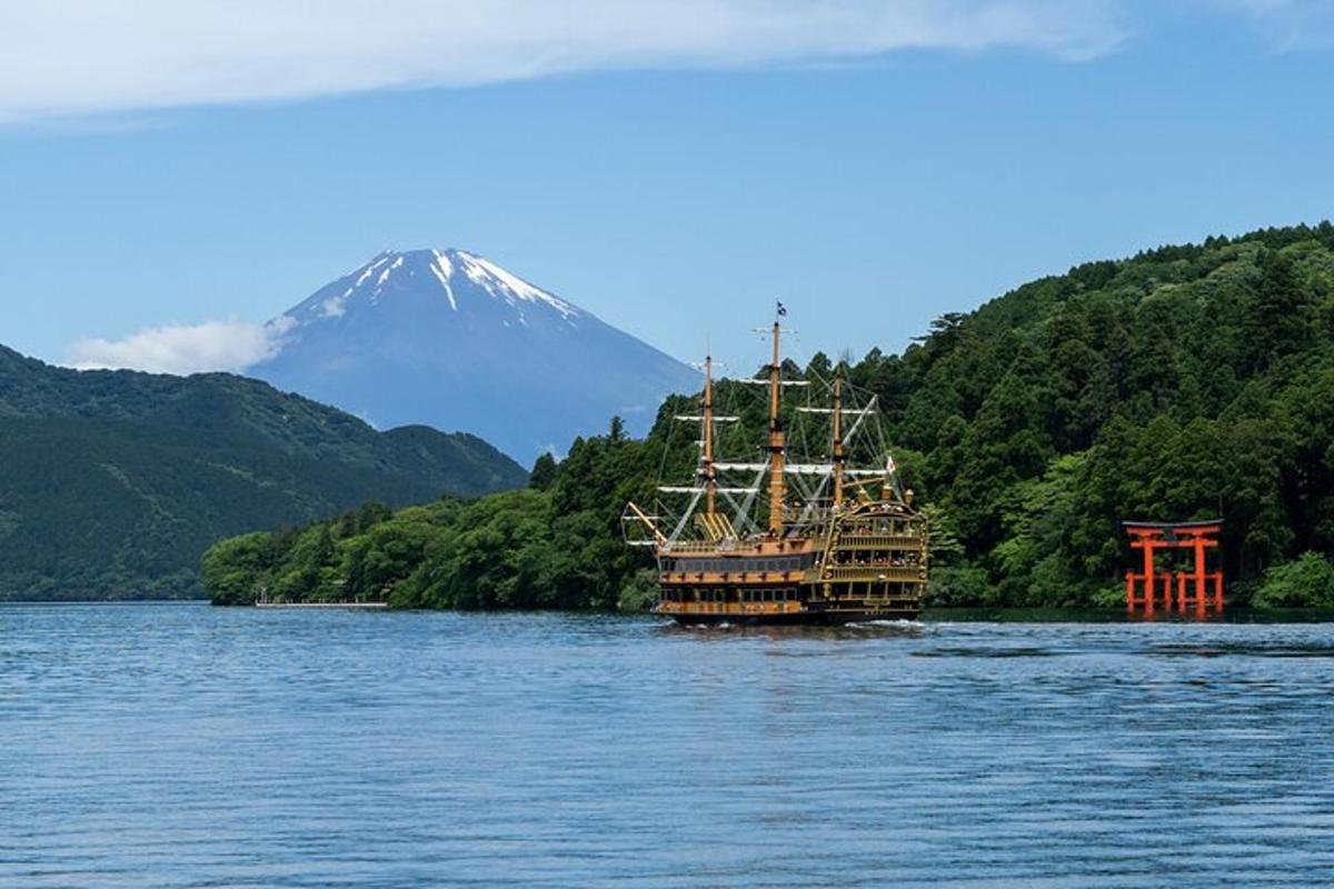a boat on the water with a mountain in the background