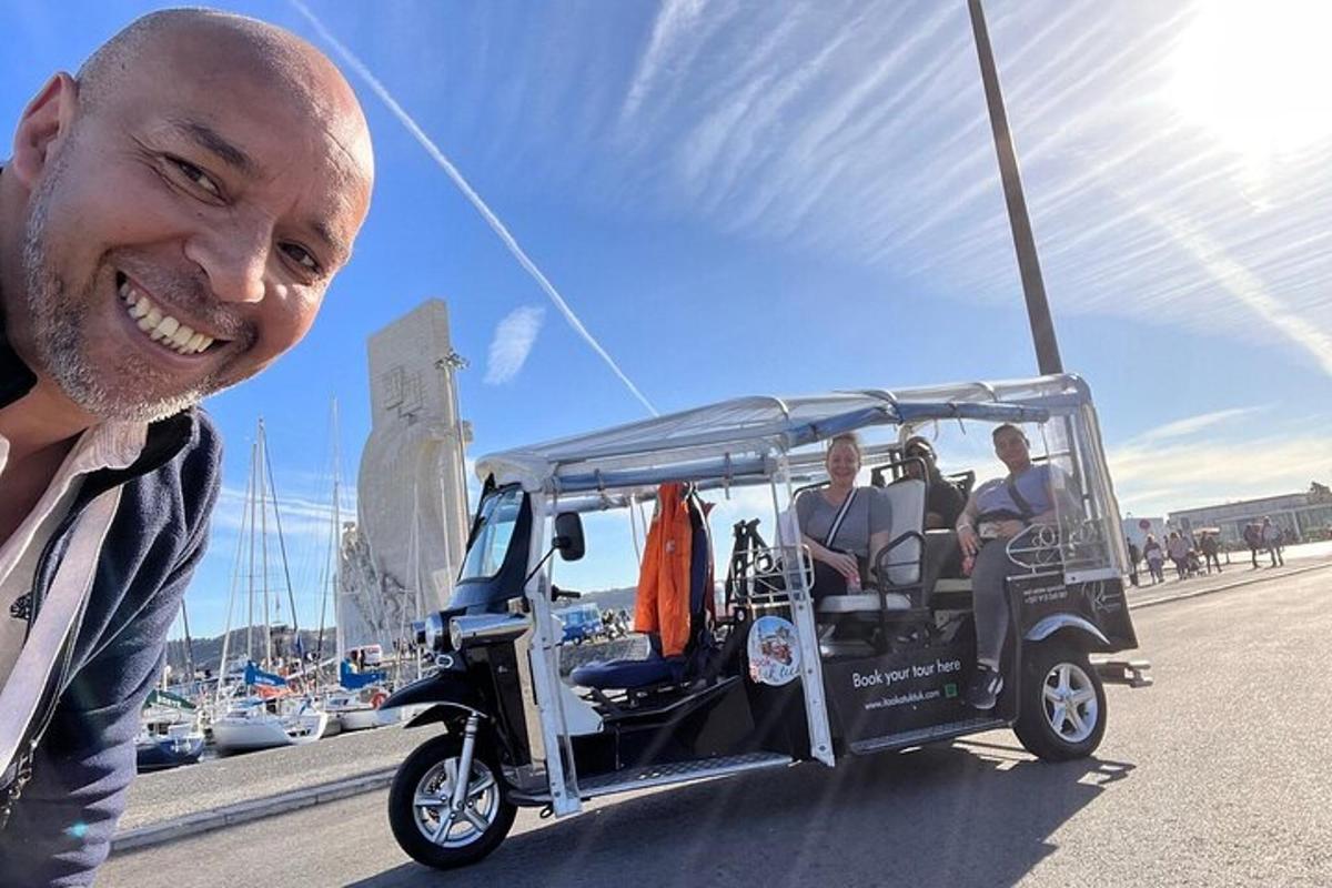 Vyras šypsosi šalia golfo vežimėlio