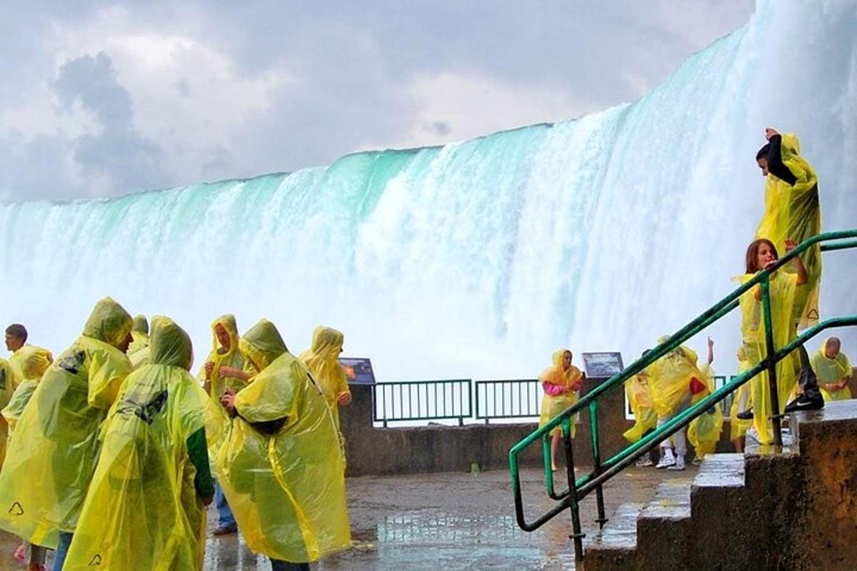 a group of people standing in front of a waterfall