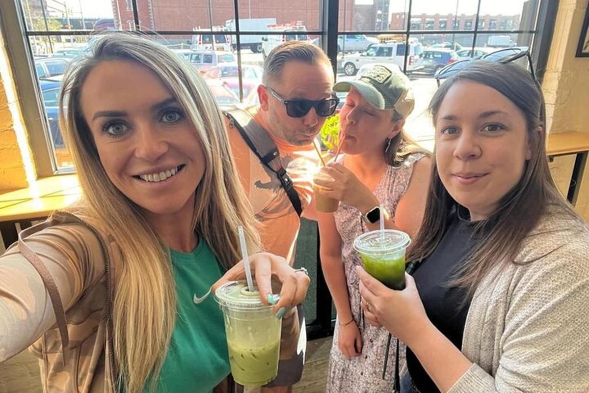 a group of people posing for a picture with drinks