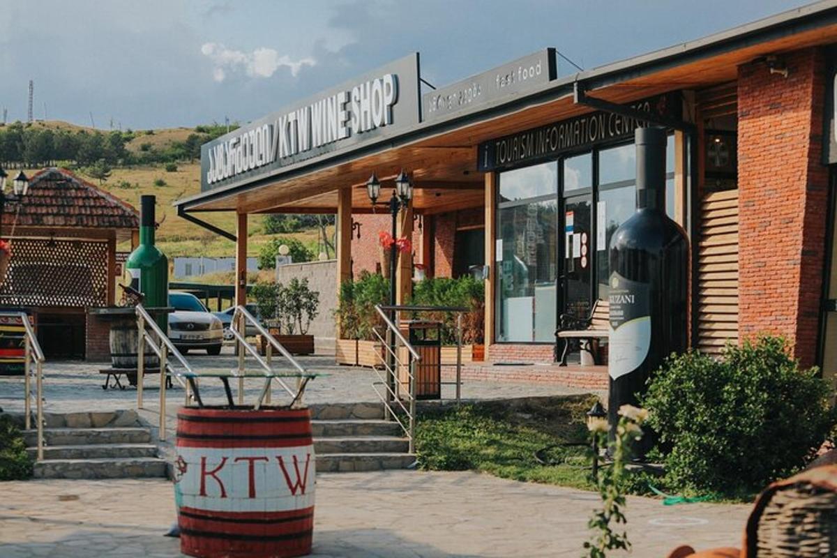 a wine shop with a barrel in front of it