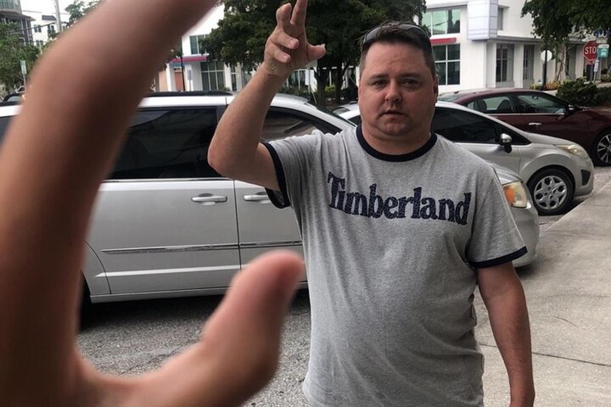 a man is taking a picture of a car