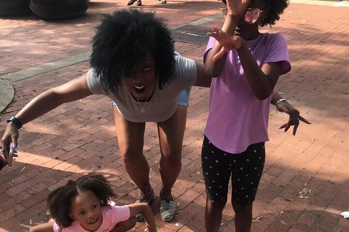 two women and a little girl on a street
