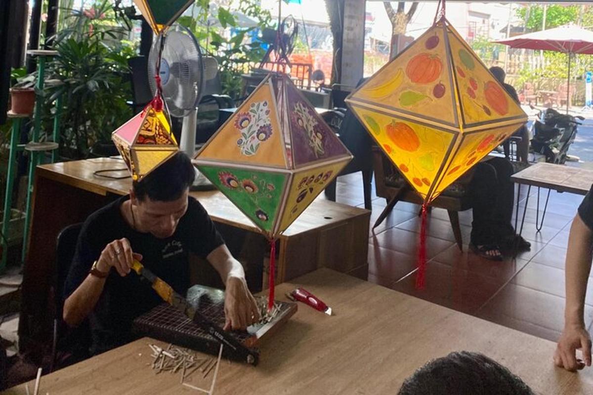a man is making kites on a table