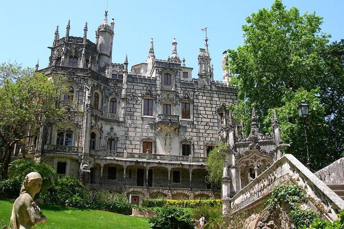 Un antiguo castillo con una estatua delante de él.