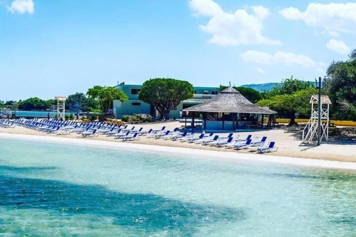 a beach with chairs and a gazebo