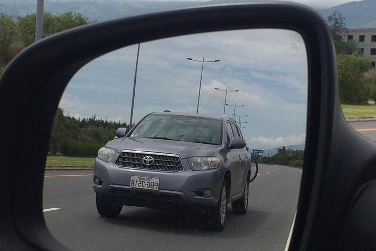 a reflection of a car in the side view mirror of a car