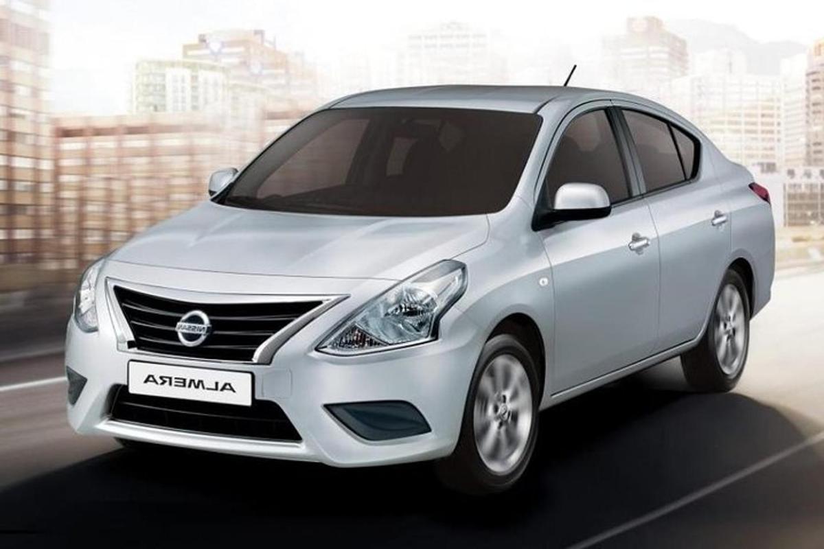 a white nissan accentamine parked in a city