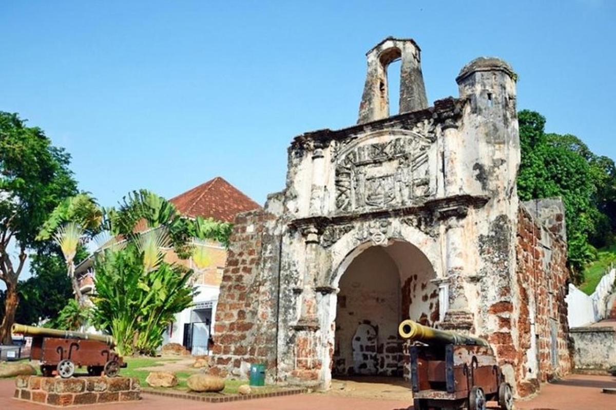 an old stone building with an arch in a yard