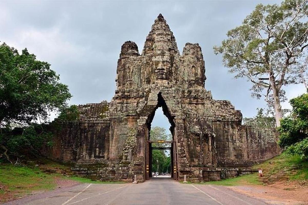 an entrance to a stone building with a bridge