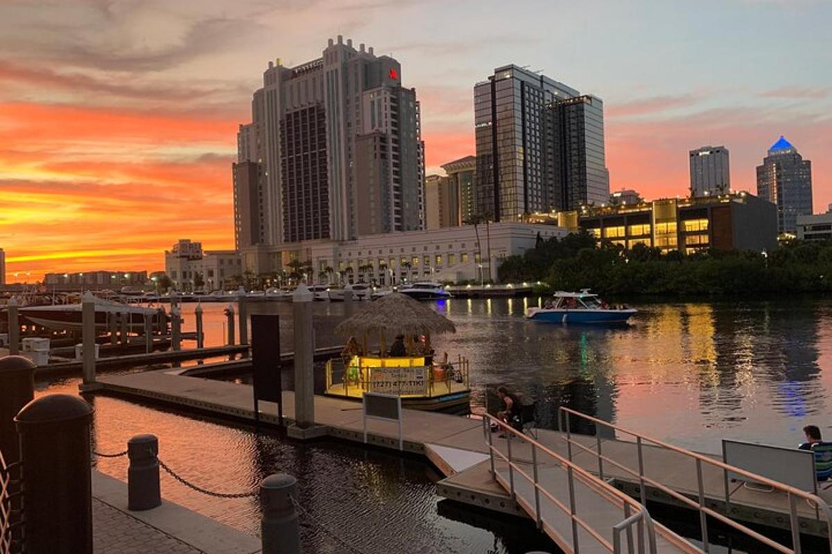 a dock with a boat on the water in a city
