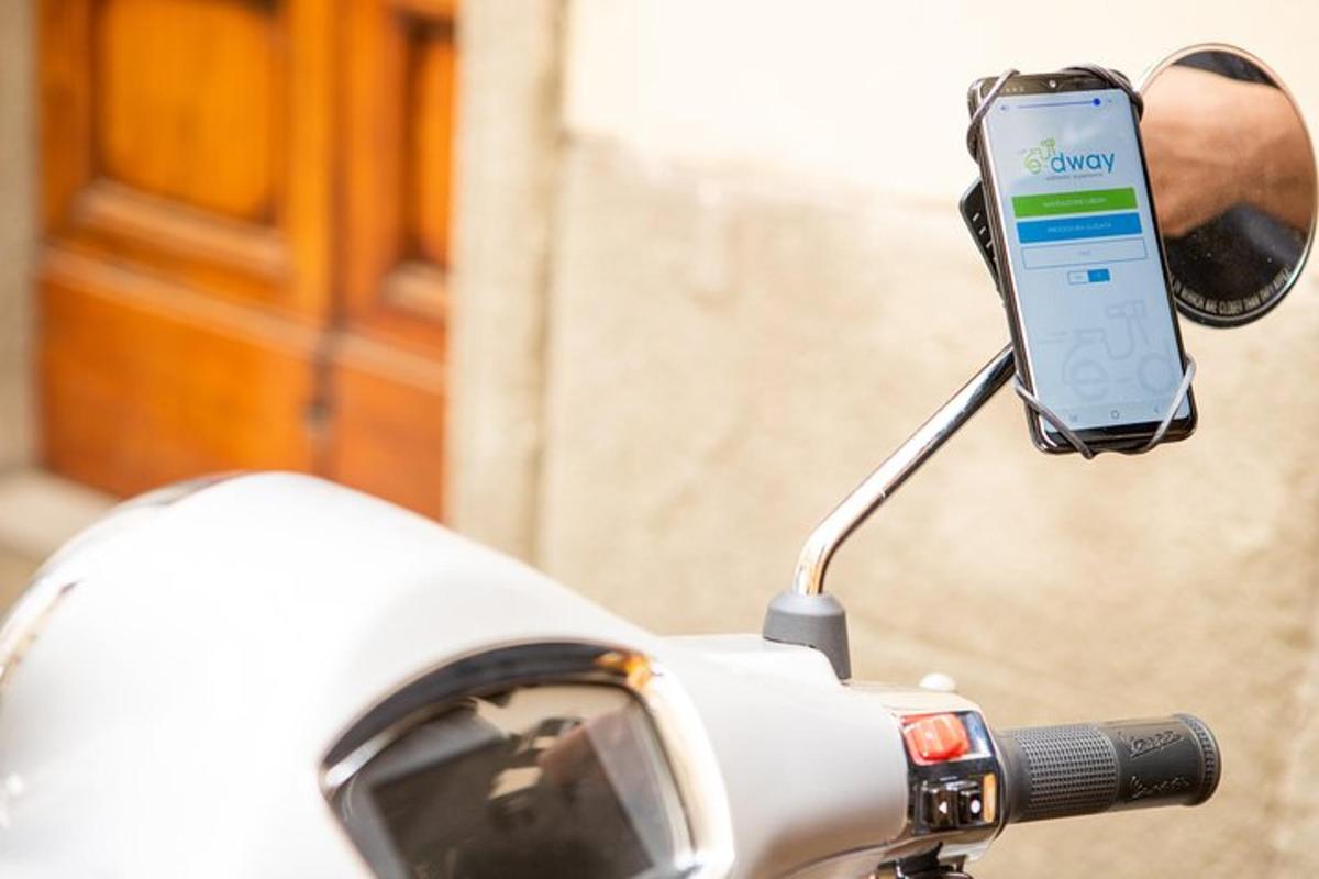 a cell phone in a side view mirror of a motorcycle