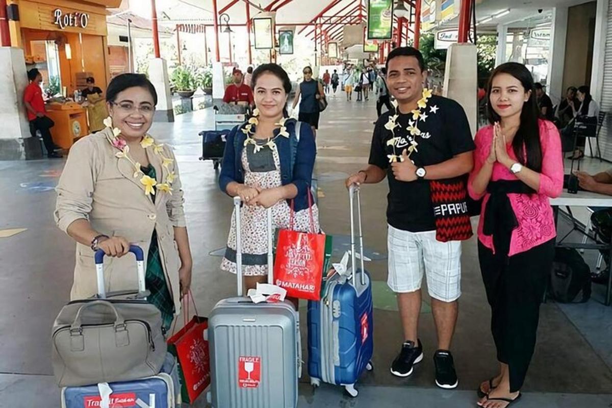 a group of people standing in an airport with luggage