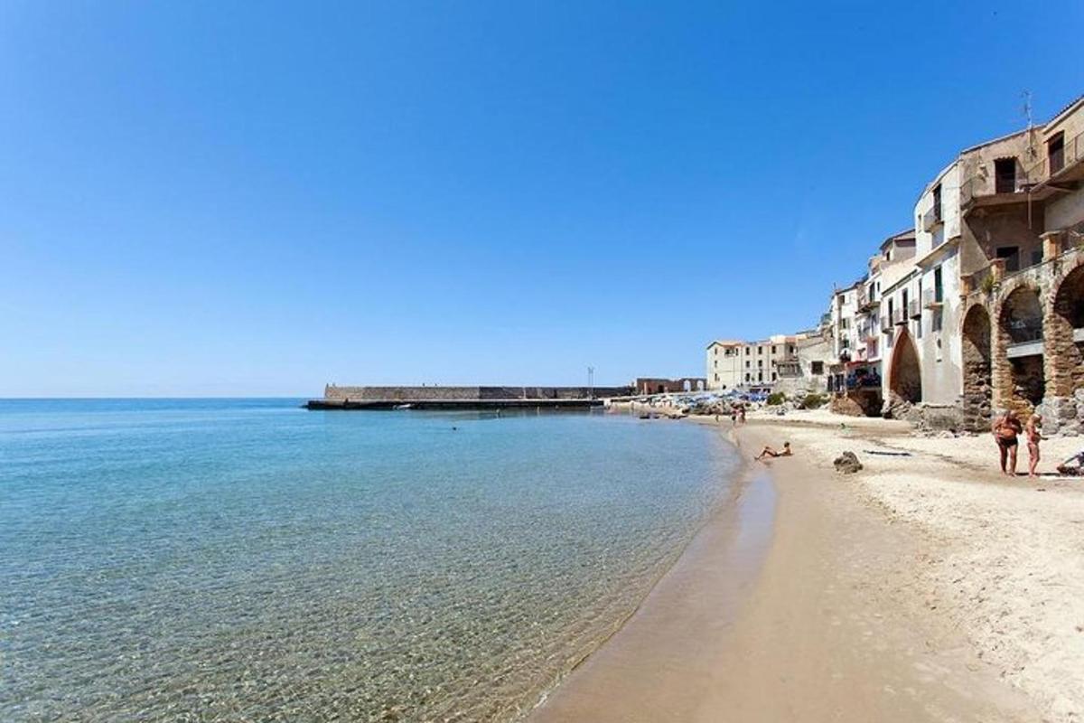a view of a beach with buildings and the ocean