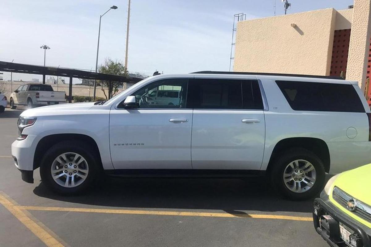 a white suv parked in a parking lot