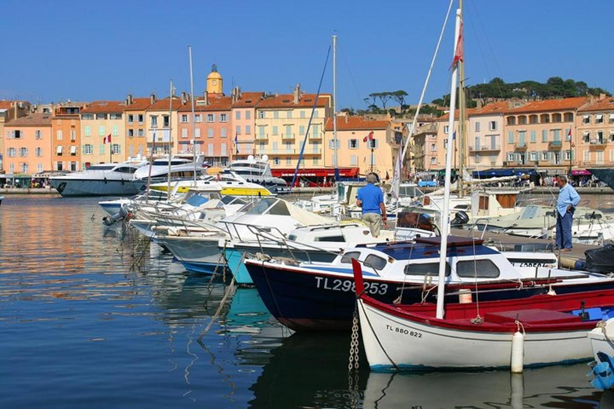 a group of boats docked in a harbor with buildings
