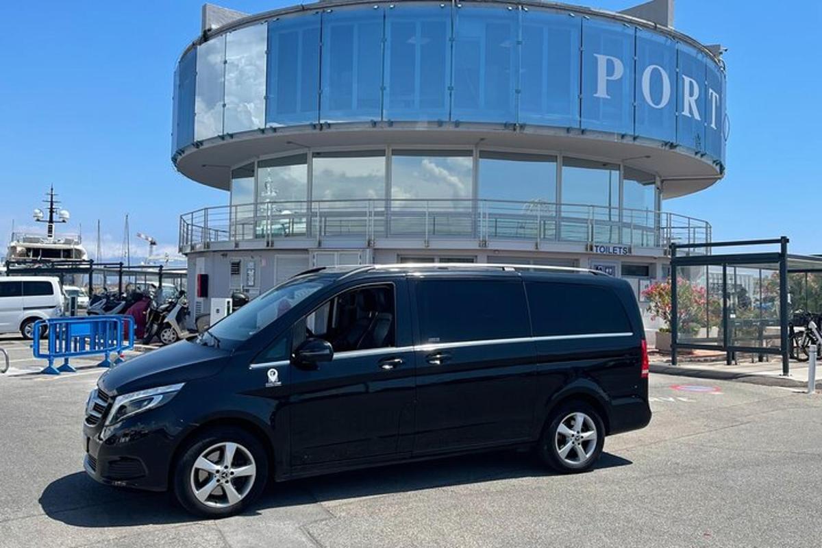 a black van parked in front of a round building