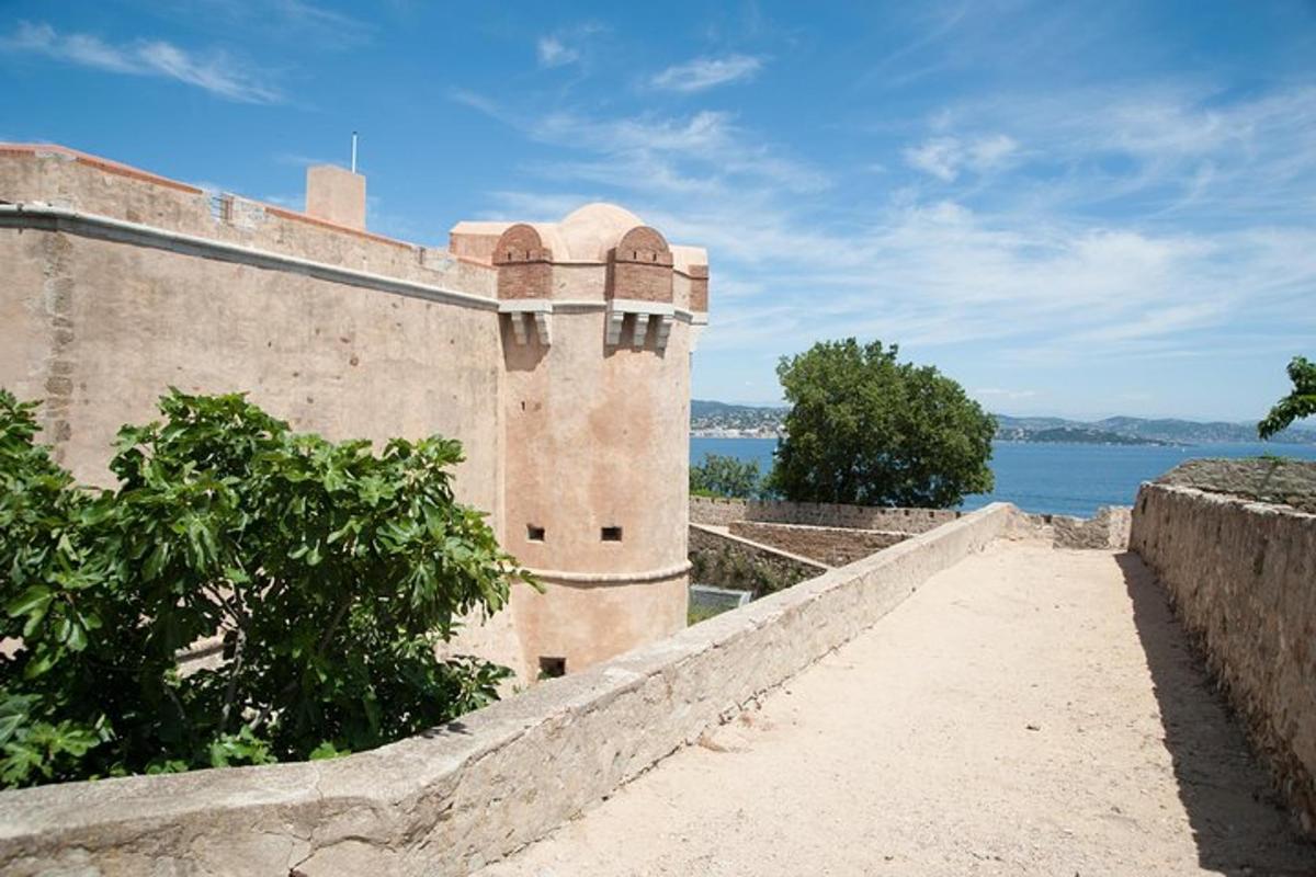 a building on the side of a wall with a body of water