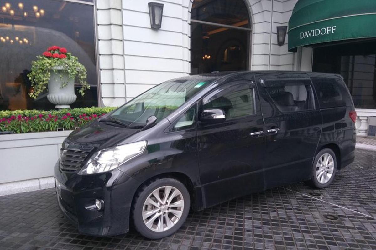 a black minivan parked in front of a building