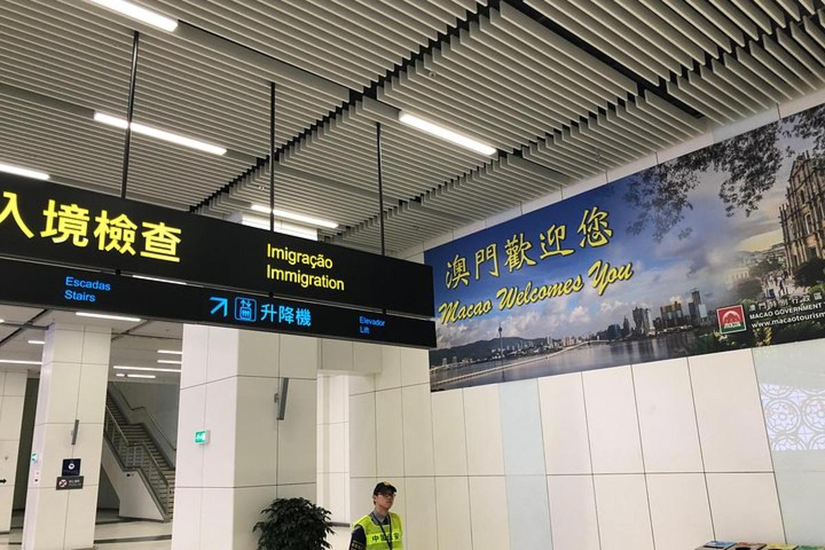 a man standing in an airport terminal with signs