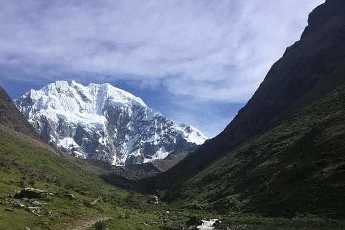uma montanha coberta de neve no meio de um vale