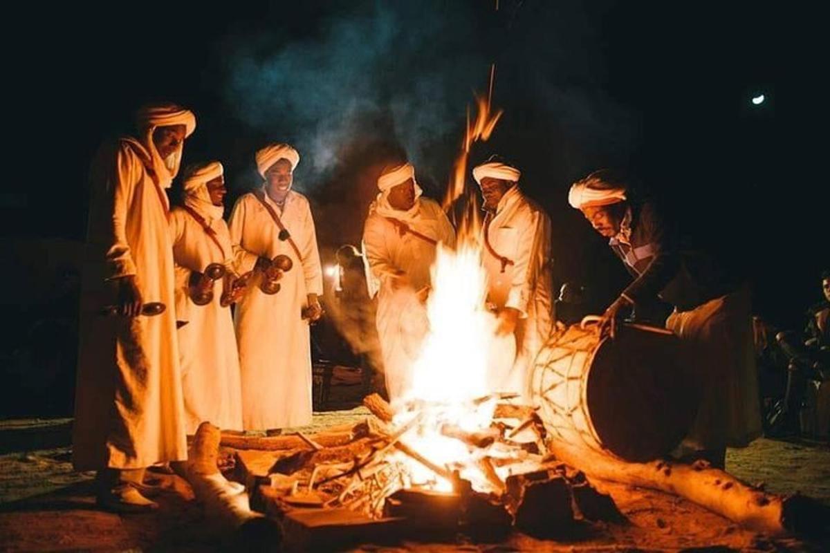 a group of people standing around a fire