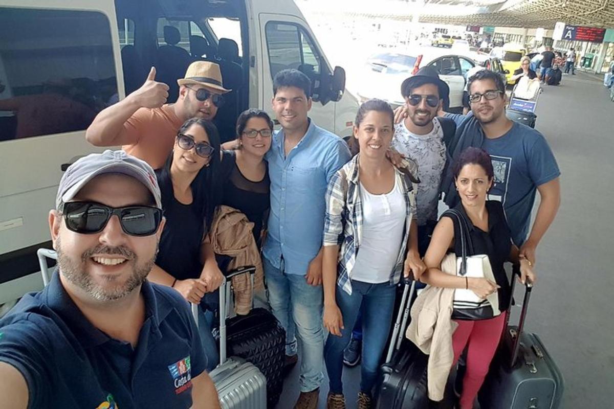 a group of people posing for a picture in front of a van