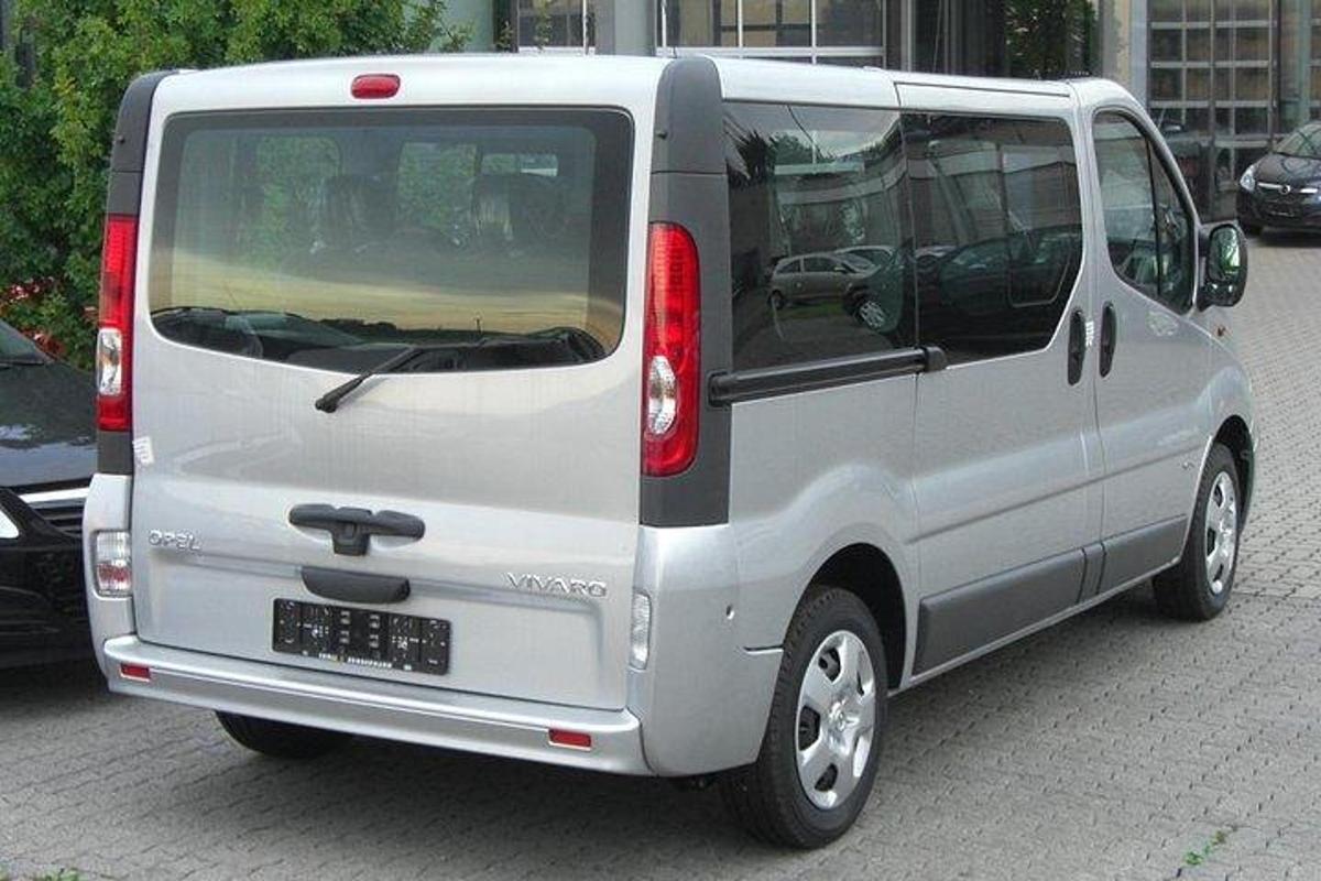 a silver van is parked on a city street