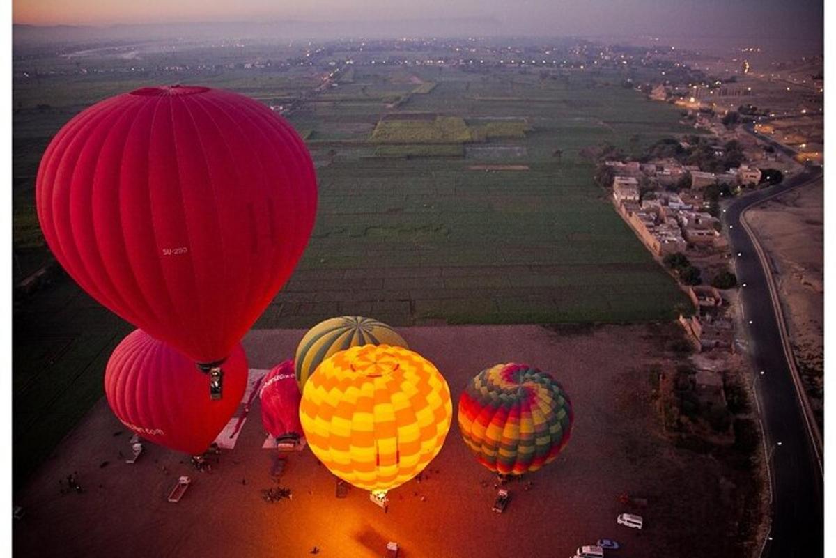 a group of hot air balloons flying over a field
