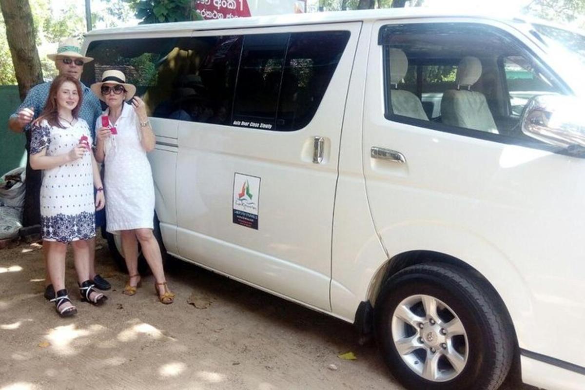a group of people standing next to a white van