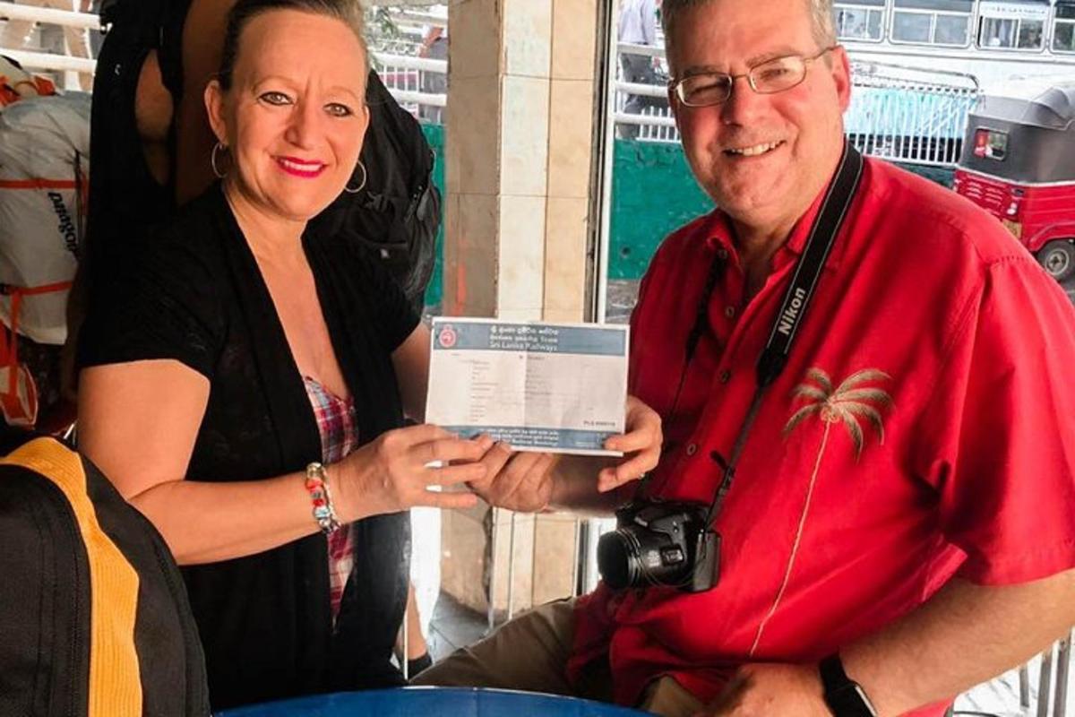 a woman holding a camera and a man holding a certificate