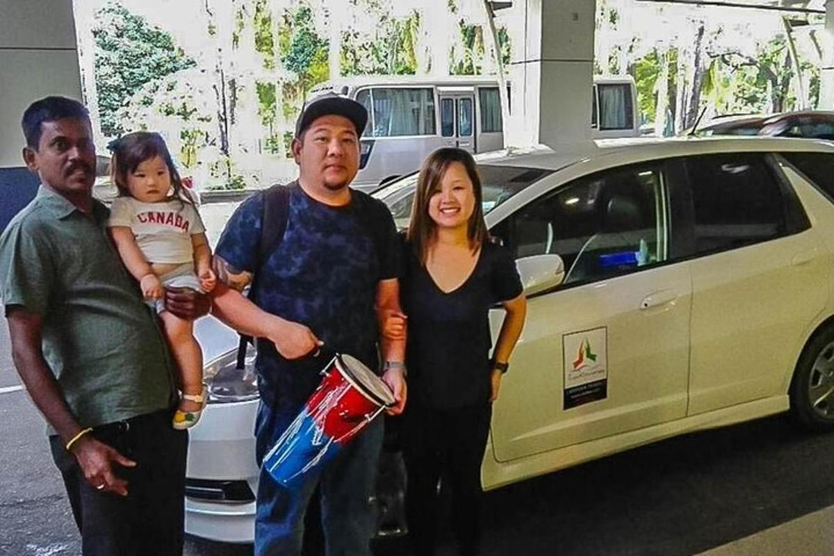 a group of people standing in front of a car