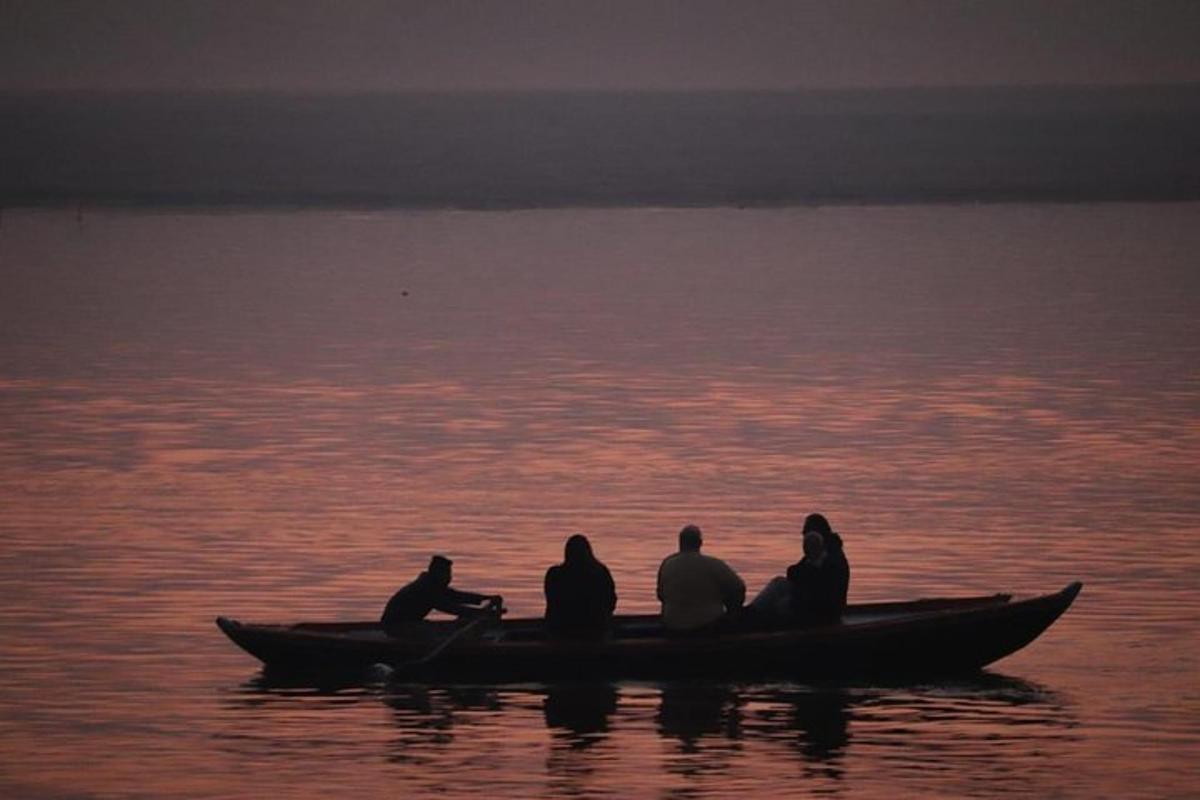 a group of people sitting on a boat in the water