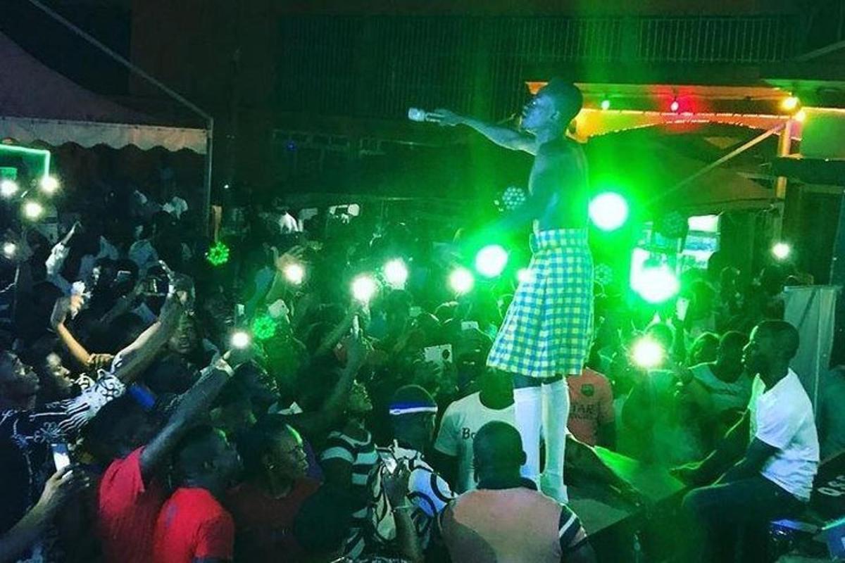 a man standing on a stage in a crowd of people