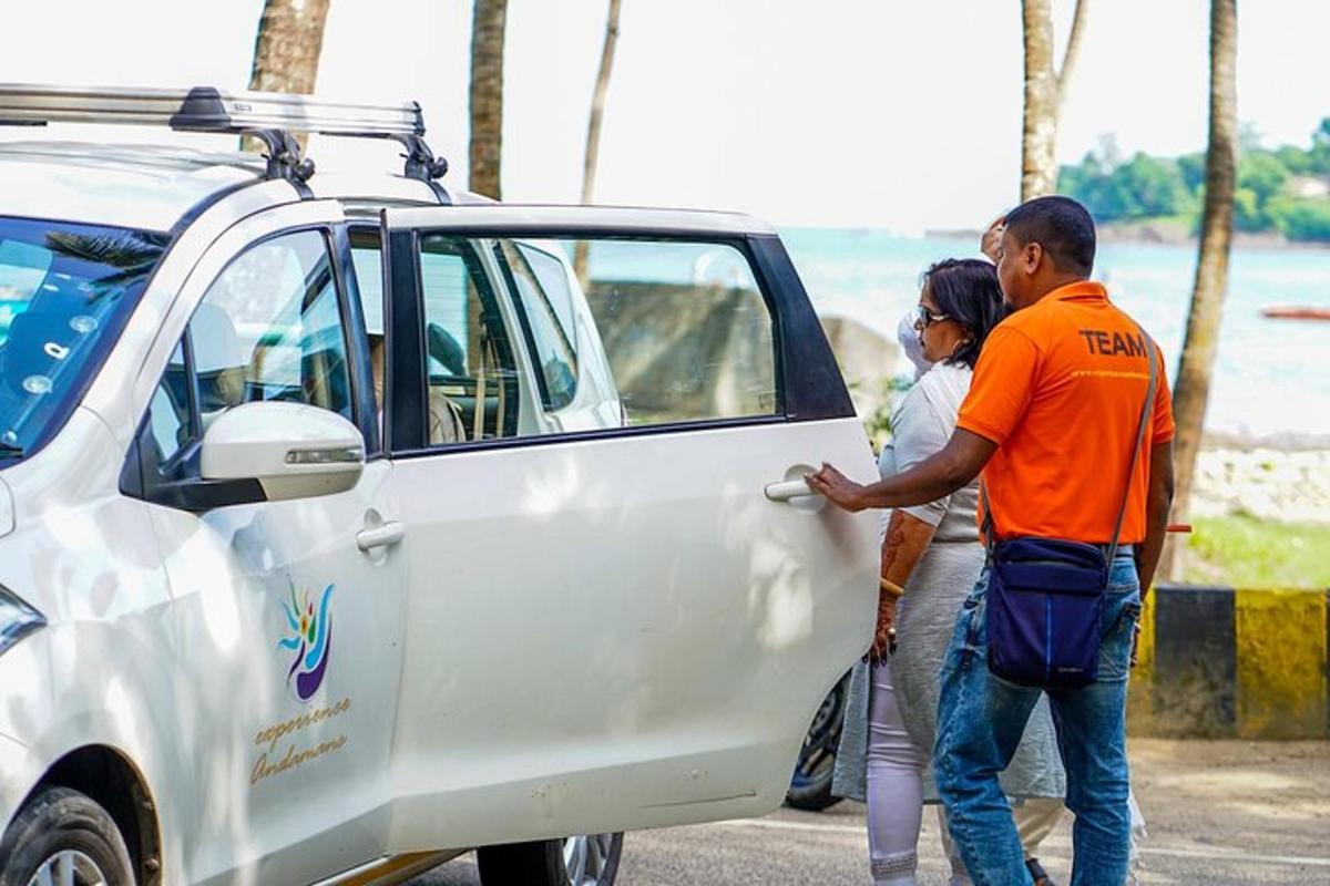 a man and woman standing next to a white car