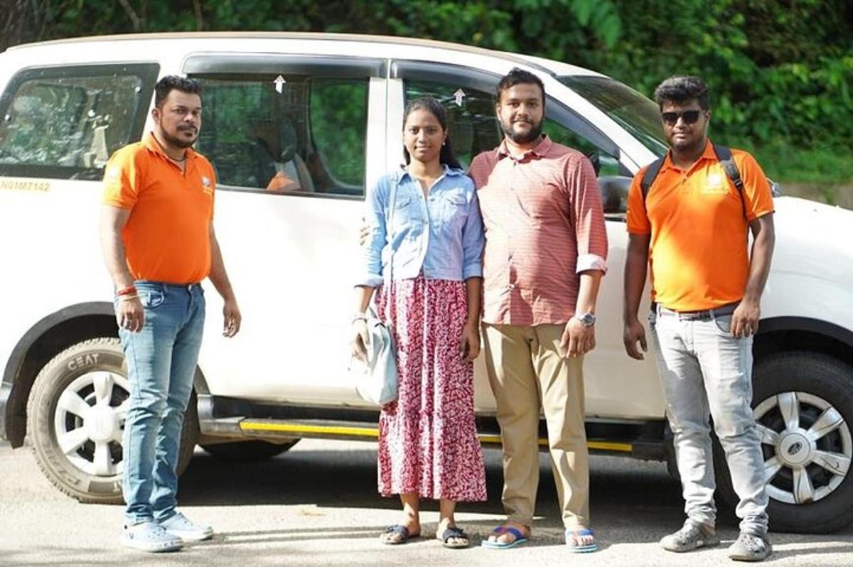 a group of people standing in front of a car
