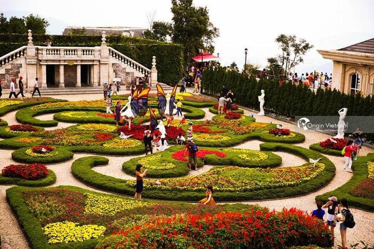 people walking around a garden in a park