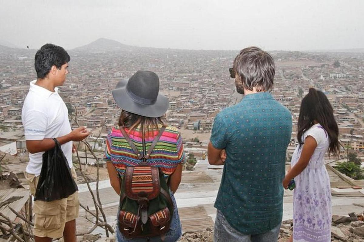 a group of people standing on a hill looking at a city