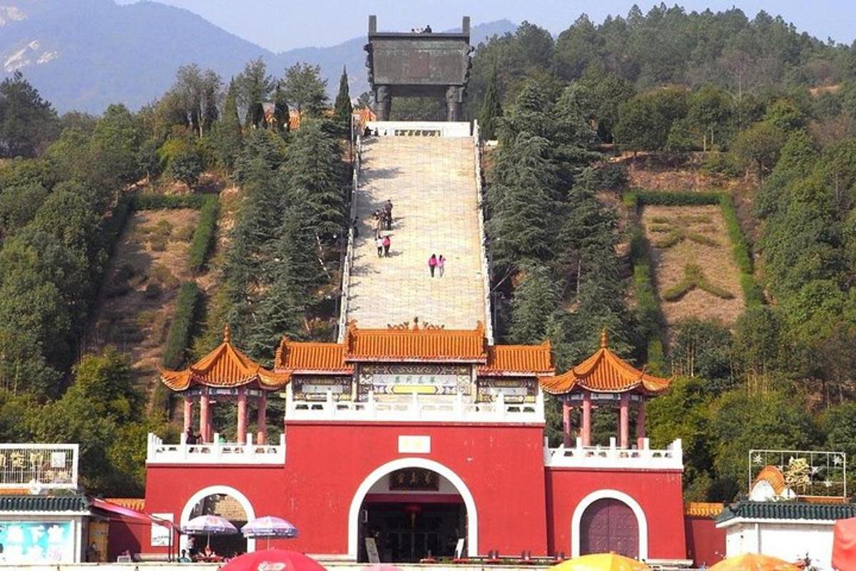 a red building with a tower on top of a hill