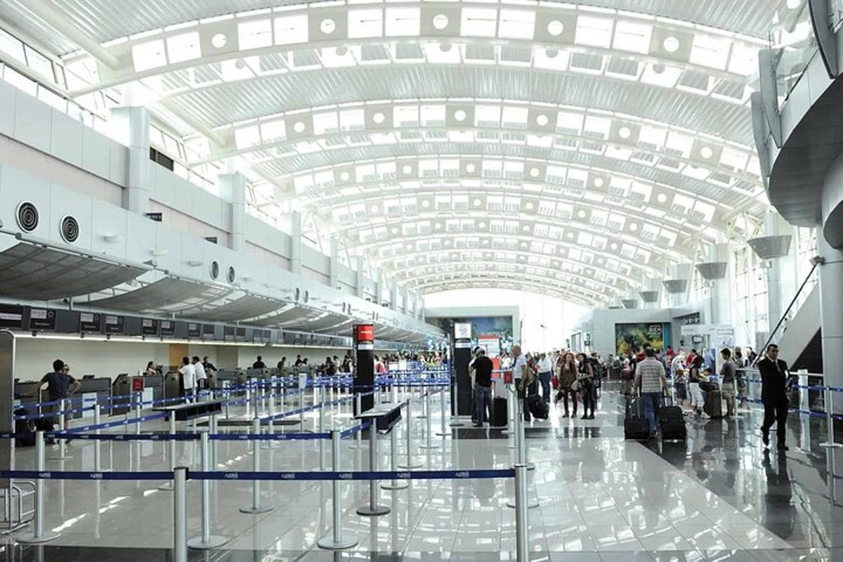 a group of people walking around an airport terminal