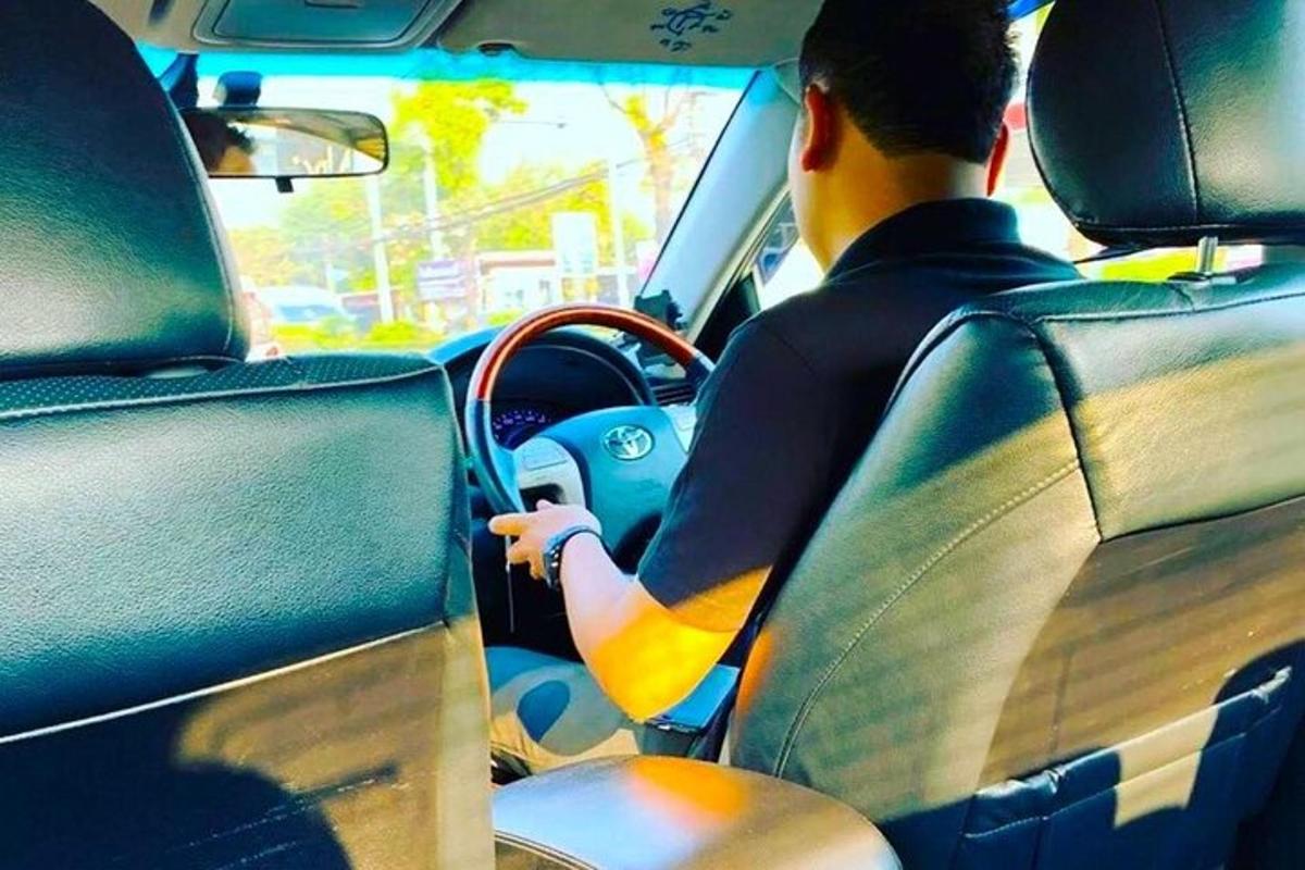 un hombre conduciendo un coche en una calle