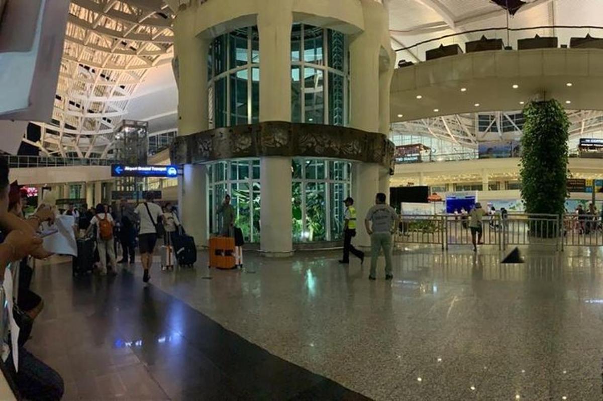 a group of people walking in an airport terminal