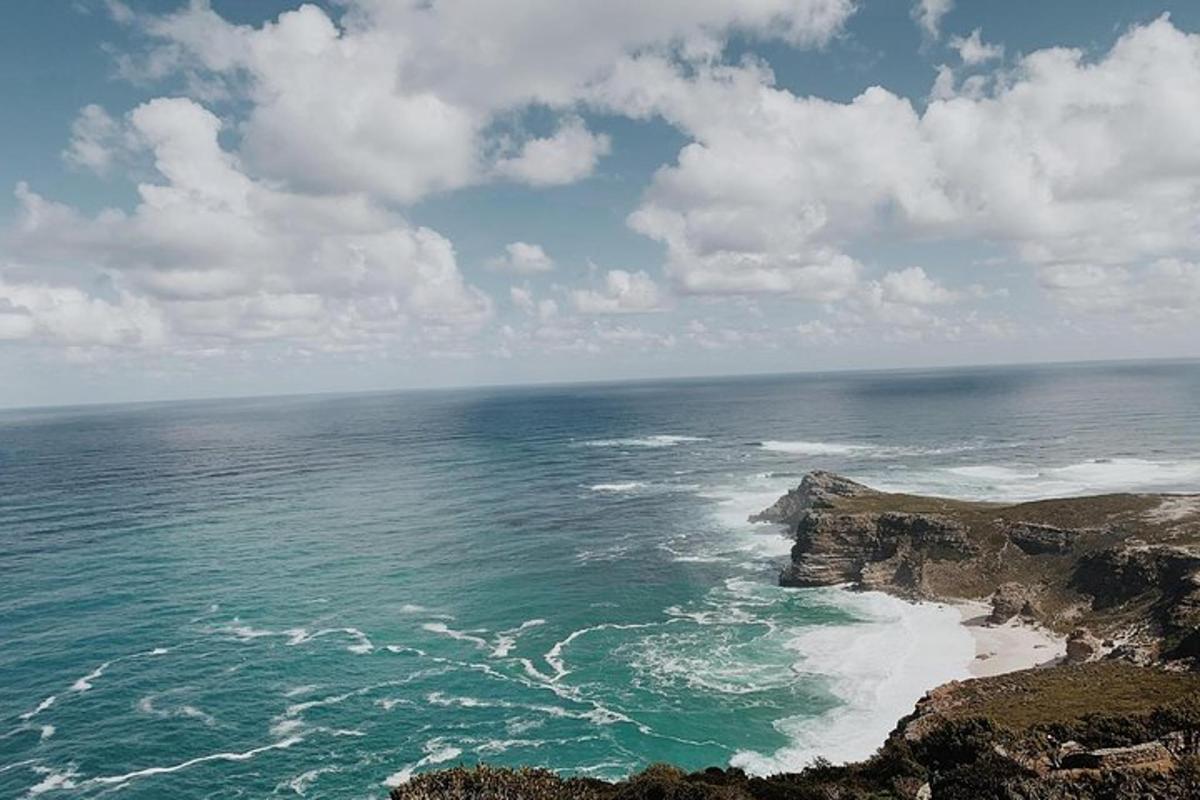 an aerial view of the ocean and a rocky coast