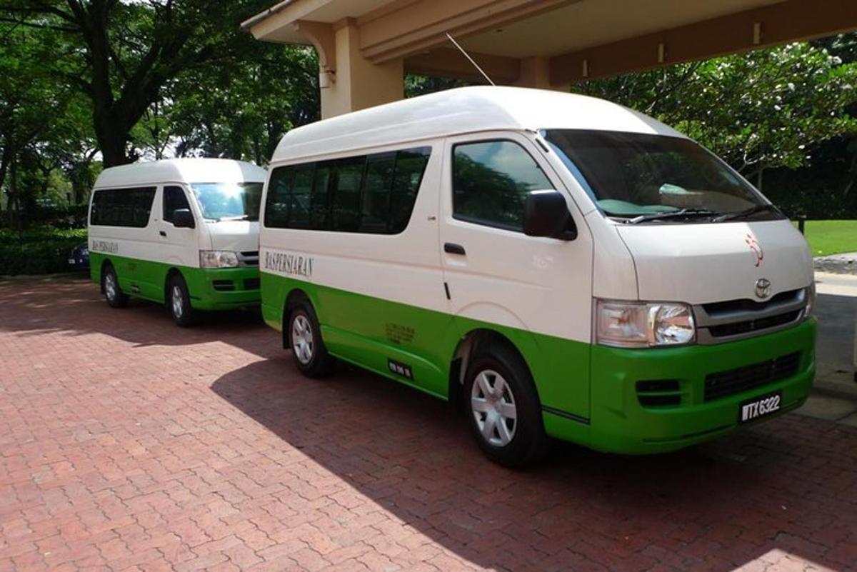 two white and green vans parked next to each other