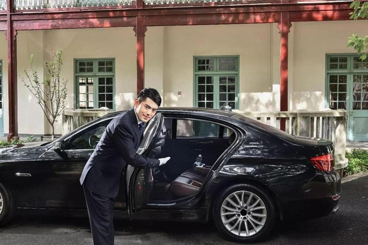 a woman is getting out of a black car
